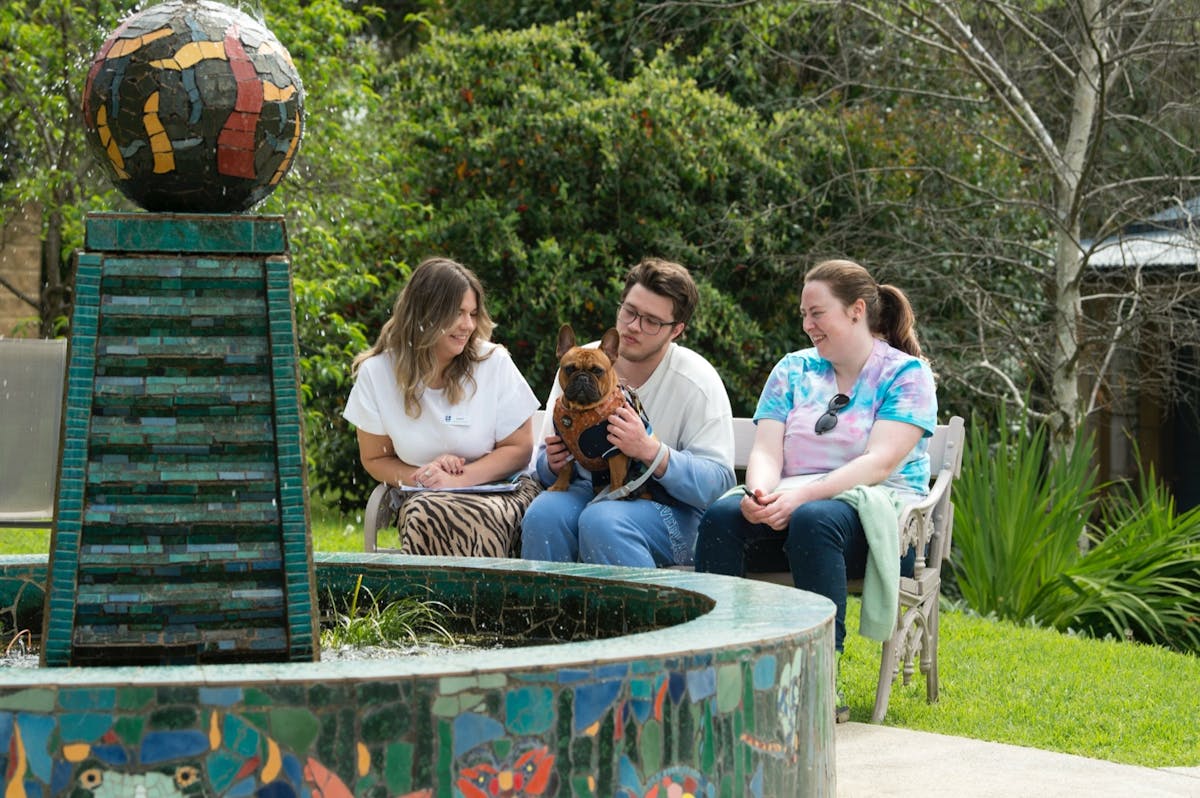 Mental health staff with a consumer, their partner and dog