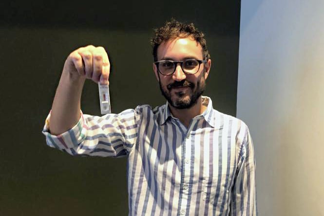 Man holding rapid antigen test