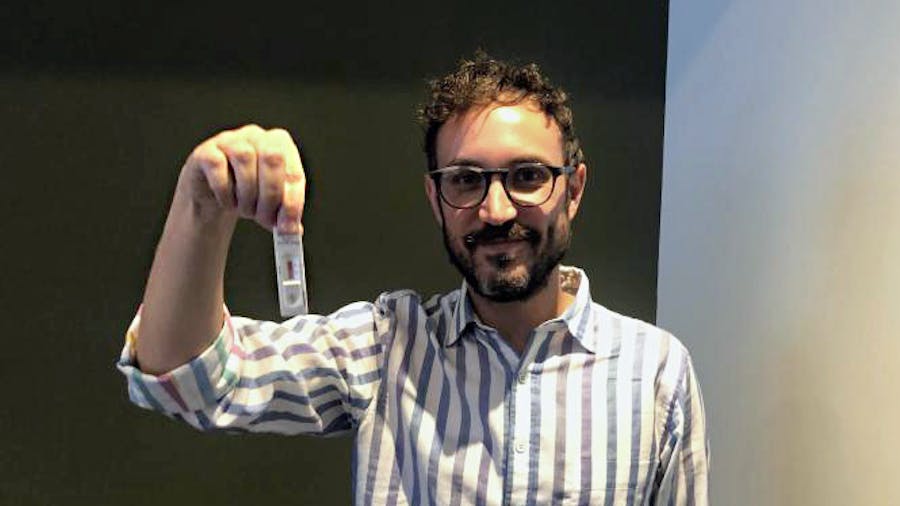 Man holding rapid antigen test
