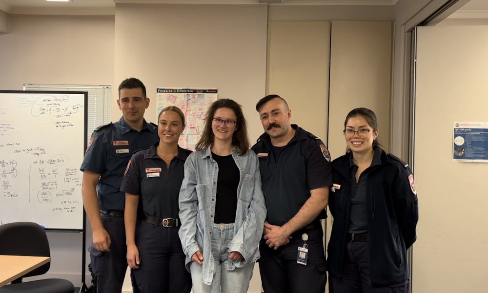 Former patient Meg with paramedics