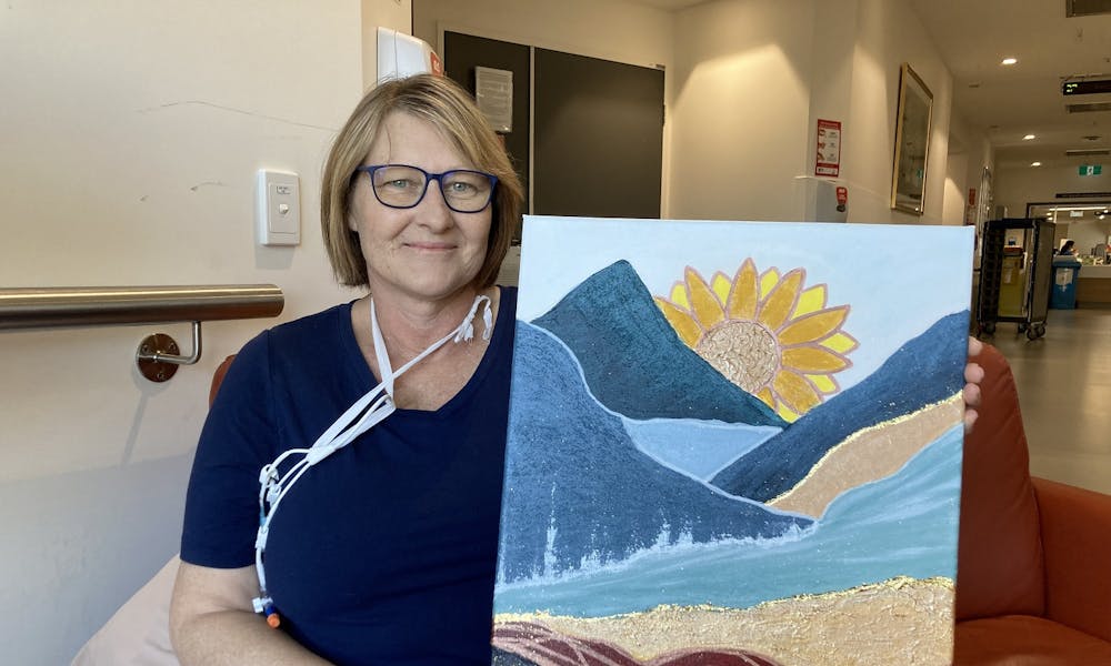 Patient Mirisa with her sunflower painting