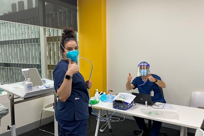 Staff give thumbs up during mask fit testing