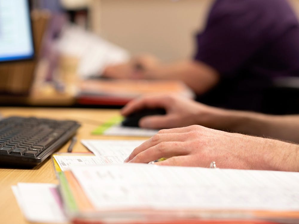 hands-using-mouse-and-keyboard-with-files-on-a-desk.jpg