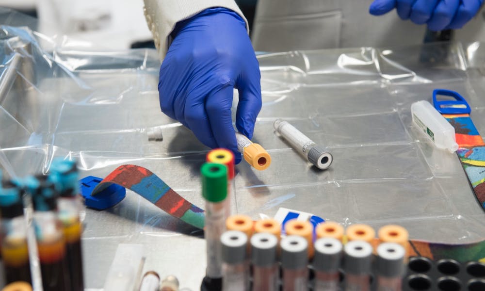 Person handling test tubes for research