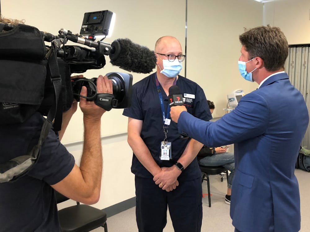 7 News reporter and camera operator interview doctor