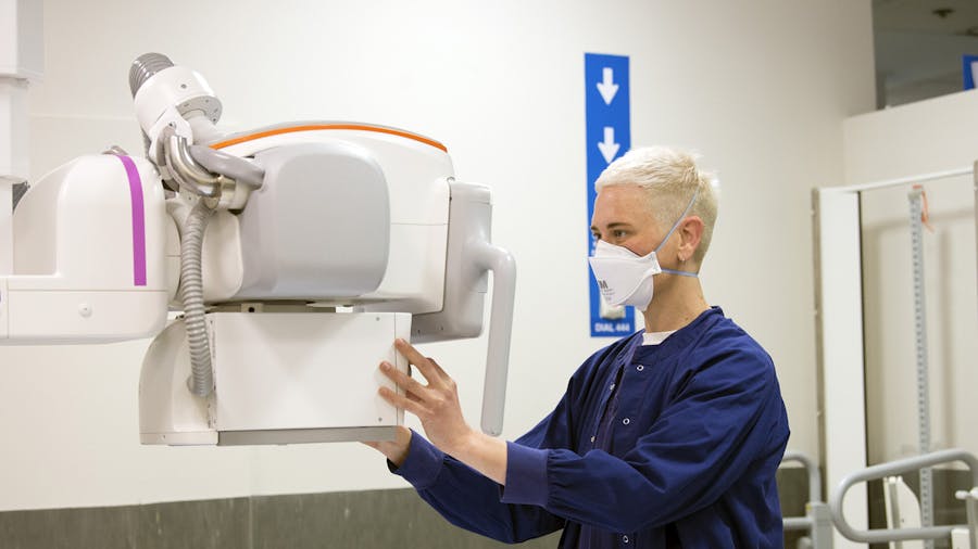 Radiology staff member operating x-ray machine