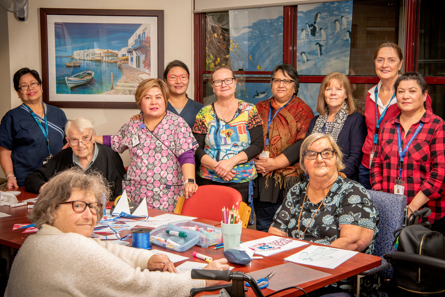 Staff and residents around arts and crafts table at Boyne Russell House