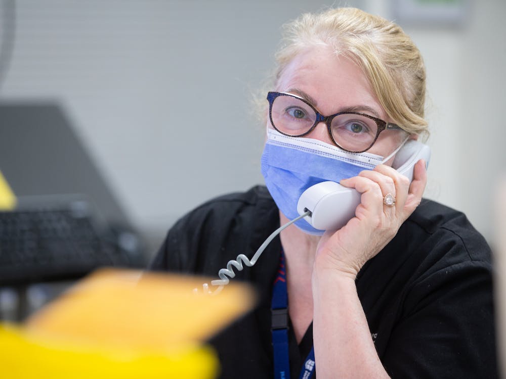 staff-member-in-mask-on-phone.jpg