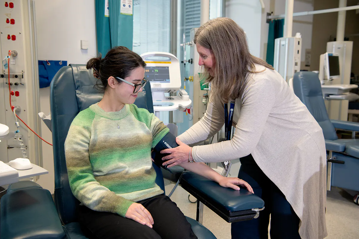 Diabetes and endocrinology patient with blood pressure cuff in Clinical Trials Centre