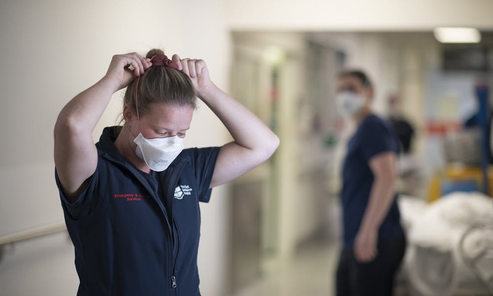Emergency Department staff putting on mask