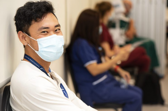 Staff member waiting for COVID-19 vaccination