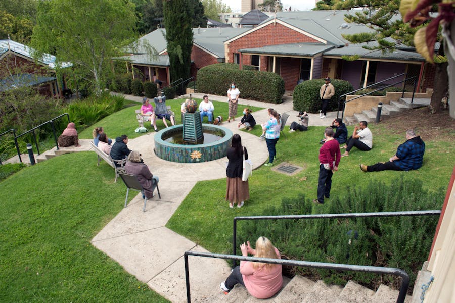 Residents and staff sit around fountain at Norfolk Terrace Community Care Unit (CCU)